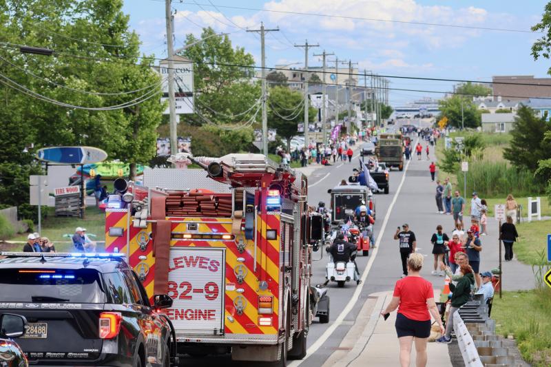 A photo that represents Lewes well: the Memorial Day Parade making its way down east Savannah Road, patriotic people honoring veterans and the Cape May-Lewes Ferry passing by Savannah Beach in the distance.