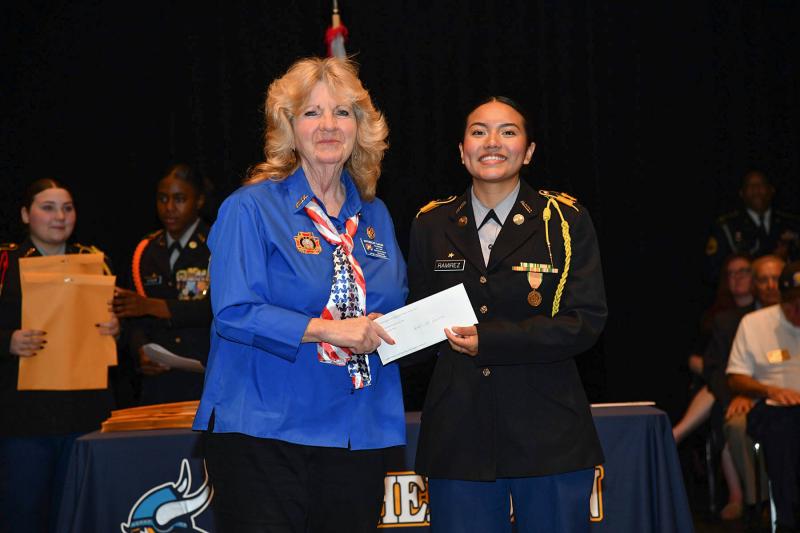 Buttercup Baker presents the Veterans of Foreign Wars Post 7447 Ladies Auxiliary Scholarship to cadet Ady Ramirez.