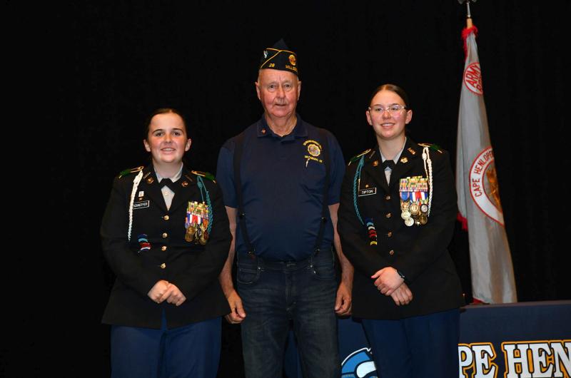 Jim Beattie presents the American Legion Post 28 Scholarship to cadets Abigail Schaeffer and Rylee Tipton.