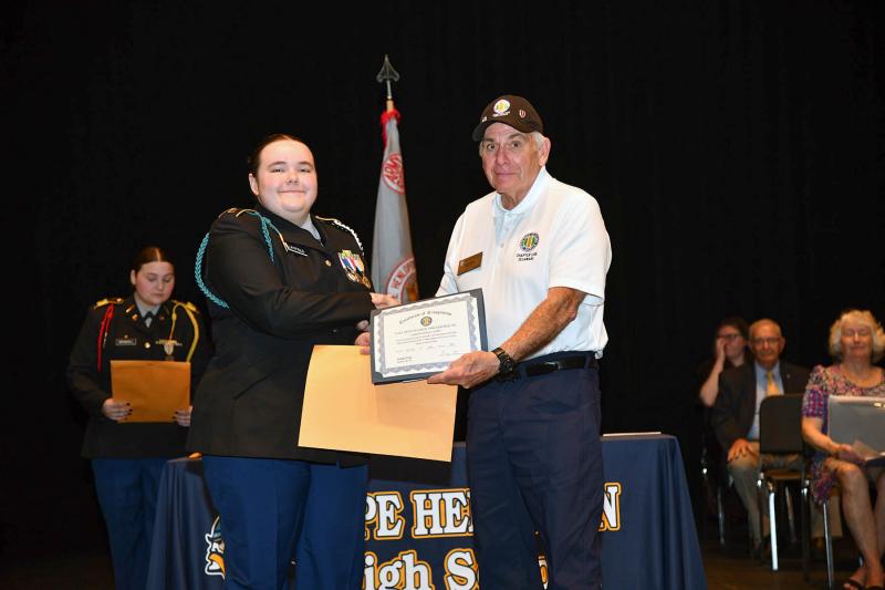 George Stone, right, of the Vietnam Veterans of America, presents a scholarship to cadet Madison Layfield.