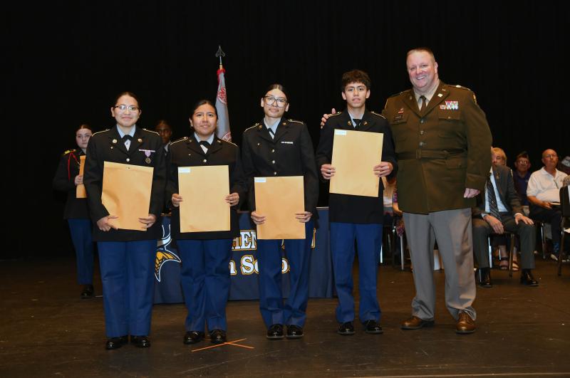 Col. Edward Dowgin presents the Senior Army Instructor Leadership Medal to cadets Stacy Ventura-Roblero, Stephanie Roblero, Miley Rivera-Perez and Andy Rodriguez.