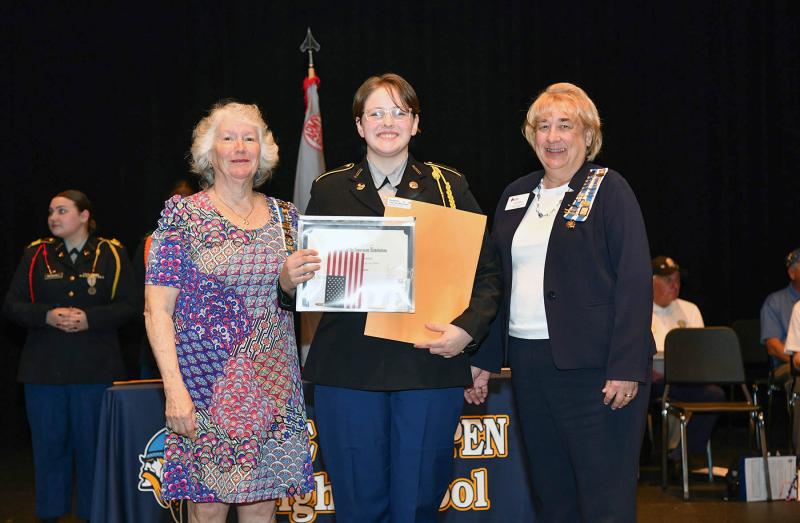 Past Regent Patricia Haas, left, and Janet Maher, vice regent, present the Daughters of the American Revolution Medal to cadet Roxanna Dalton.