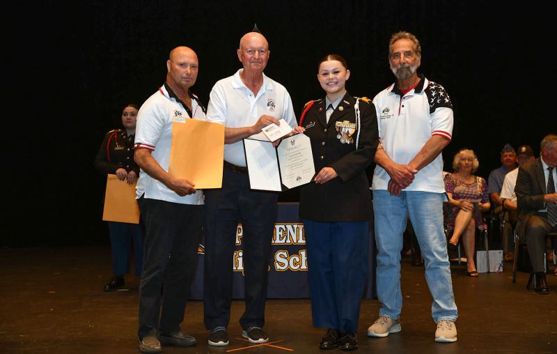 Bob Trafton, Marty Schreck and Dan Celia present the Cape Henlopen Elks Lodge Post 2540 Award and Scholarship to cadet Gianna Decker.