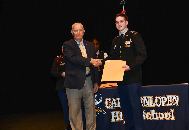 The Fort Miles Historical Association Medal is presented to cadet Kyle Nantz by retired Sgt. Maj. Tom Blakely.