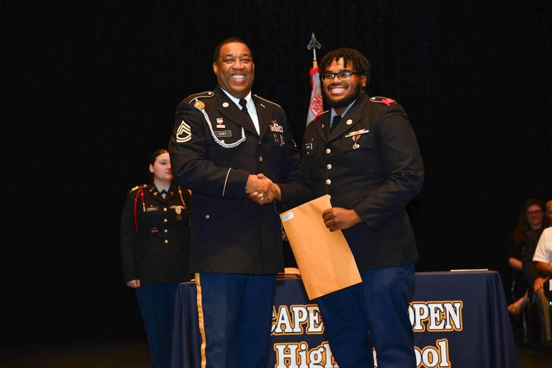 Sgt. First Class Richard Hurt presents the Non-Commisioned Officers Association Medal to cadet Laniel Joynes.