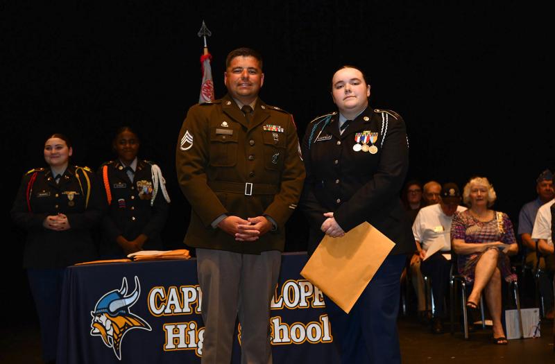 Staff. Sgt. Mauldin presents the United States Army Recruiting Command Award to cadet Madison Layfield.