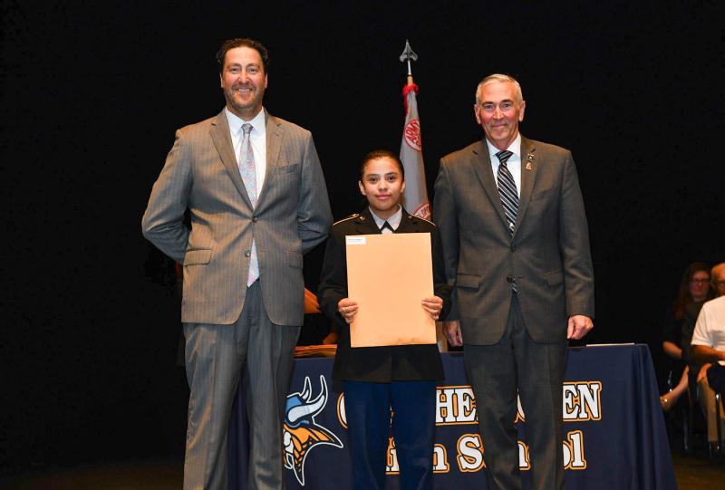 Maj. Gen. Fran Mahon and Andrew Coulter present the JROTC Proficiency Medal to cadet Shary Perez-Ochoa.