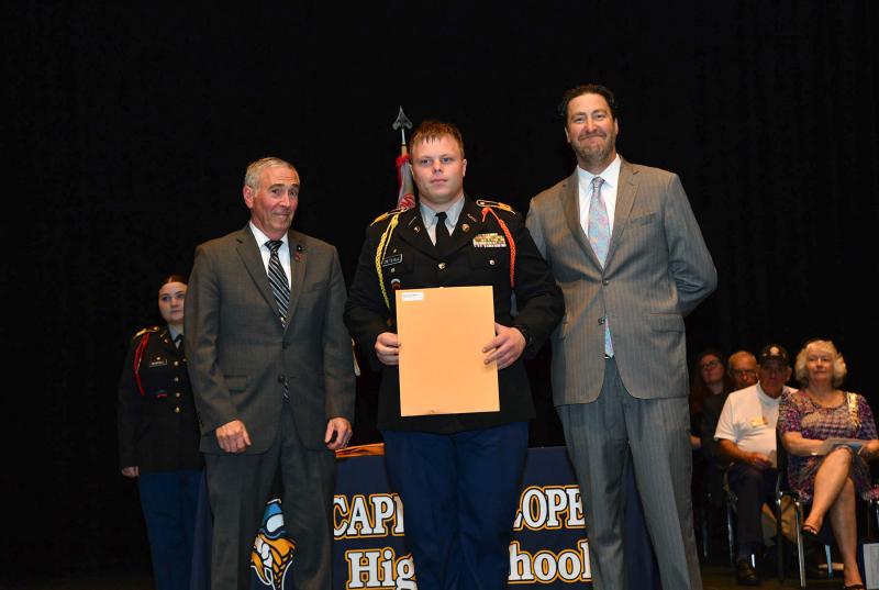 Maj. Gen. Fran Mahon and Andrew Coulter present the Best Staff Officer of the Year to cadet Brent Dieterle.