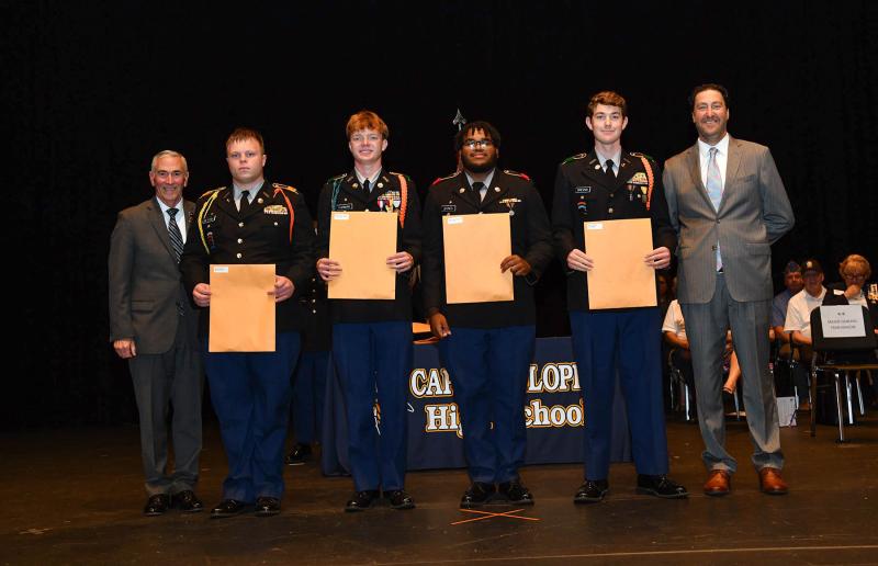 Maj. Gen. Fran Mahon and Andrew Coulter present the Best Staff Officer of the Year to cadet Brent Dieterle, Best Platoon Leader of the Year to cadet Mason Furman, Best Platoon Sergeant of the Year to cadet Laniel Joynes and Best Company Commander of the Year to cadet Liam Drevno.