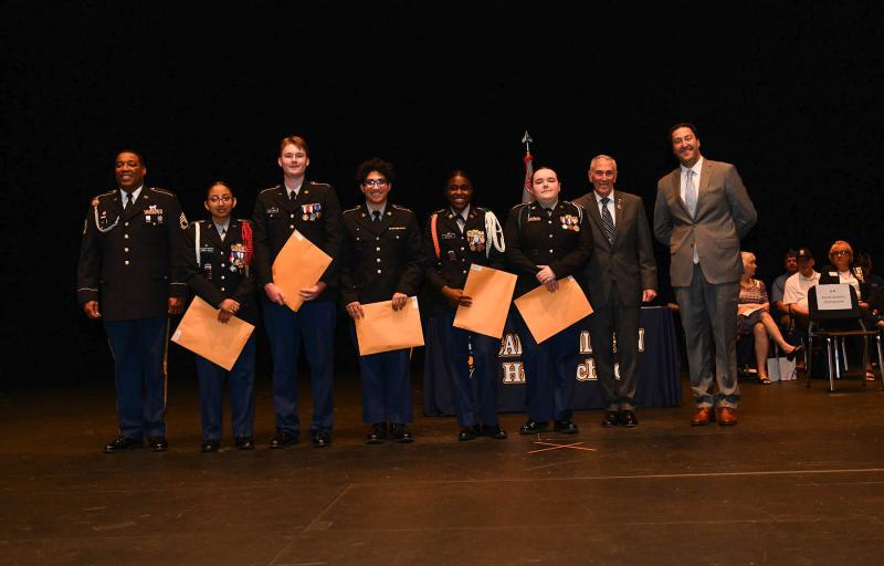Maj. Gen. Fran Mahon and Andrew Coulter present Special Team Most Valuable Cadet Awards to cadets Jazmine Ramos Trejo, drill team; Cole Huxtable, JLAB team; Bijan Sorab, Raider Team; Cianna Steer, color guard; and Madison Layfield, robotics team.