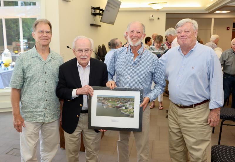 The Greater Lewes Foundation honors Dennis Forney, Cape Gazette co-founder and publisher emeritus, with a photo of Lewes Canalfront Park at its annual meeting May 17. GLF is celebrating its 25th anniversary. It is currently managing several major philanthropic campaigns in the city. Shown are (l-r) former Mayor Jim Ford, Fourth Street Preserve open space campaign chair; Joe Stewart, GLF board chair; Forney; and Mike Rawl, GLF executive director. BILL SHULL PHOTOS