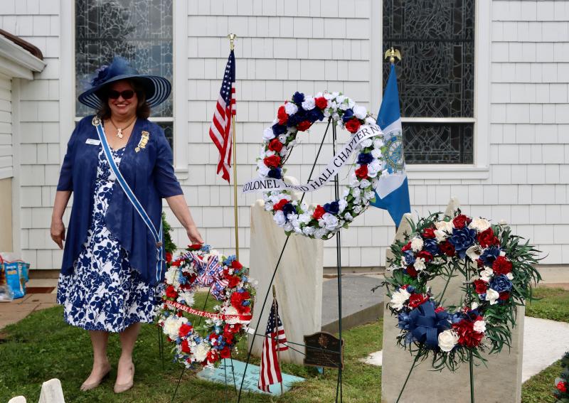 Barbara Seningen, regent, Delaware State Society, Daughters of the American Revolution, lays a wreath at the grave of Col. David Hall.