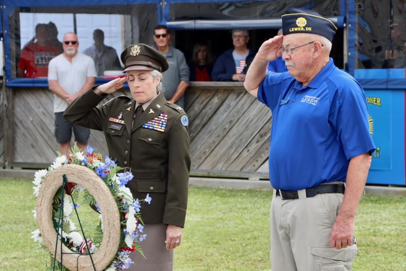 Col. Laurie Spraga, U.S. Army, left, and Michael Mulligan, American Legion Post 17 commander, lay a wreath outside the post headquarters in remembrance of fallen service members.