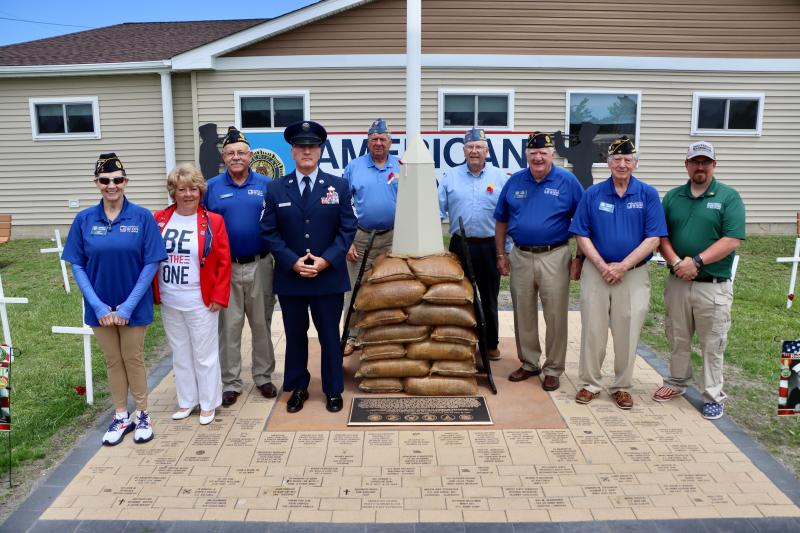 Post 17 leaders gather in front of their memorial at the post home headquarters on American Legion Road. The memorial has bricks dedicated to fallen service members. There are benches placed around it honoring all branches of the armed forces.
Shown are (l-r) Michelle Williams, Post 17 historian; Kelly Bergan, Auxiliary Unit 17 president; Michael Mulligan, Post 17 commander; retired CMSgt. Michael Bellerose; Matt Williams, Squadron 17 commander; Doug Spellman, Squadron 17 adjutant; Dan Catts, Post 17 finance officer; Vernon Garris, Post 17 judge advocate; and Brandon Zeitler, Post 17 sergeant at arms.