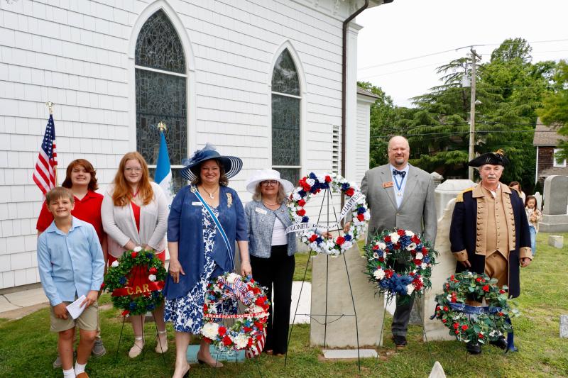 Representatives of several organizations laid wreaths on the grave of Col. David Hall at Lewes Presbyterian Church. Shown are (l-r) Asher Foxwell; Harper Hudson; Annabelle Hudson; Barbara Seningen, regent, Delaware State Society, Daughters of the American Revolution; Beth Bowersock, regent, Col. David Hall Chapter, Daughters of the American Revolution; Troy Foxwell, president, Delaware State Society, Sons of the American Revolution; and Allen Geenly, treasurer general of the National Society of the Sons of the American Revolution.