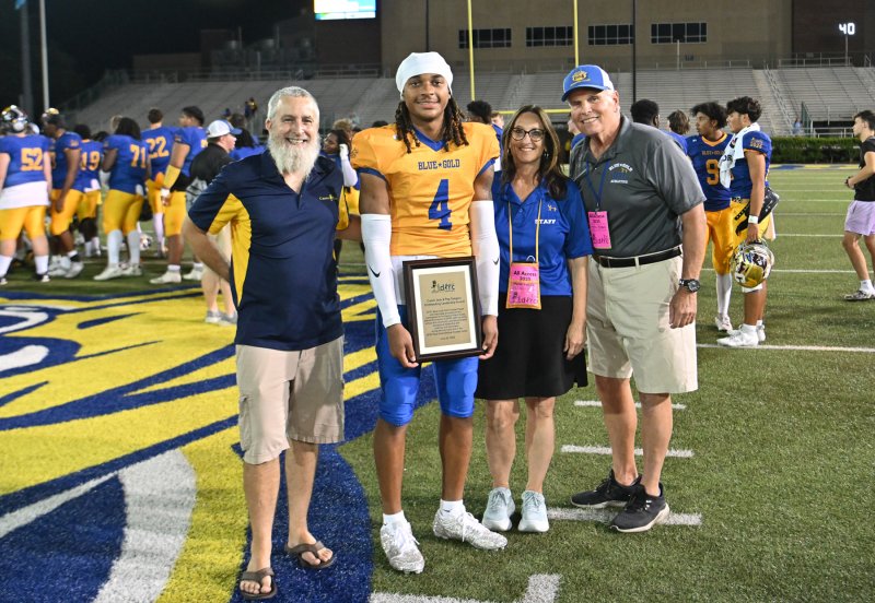 The Coach Jack and Peg Gregory Outstanding Leadership Award was presented to Emory Womack of St Georges. Shown are (l-r) Tom Souter of Crown Trophy, Emory Womack of St. Georges Tech, DFRC Executive Director Marie Vacca and Dr. Tony Glenn, honorary game day chair and former DFRC executive director.