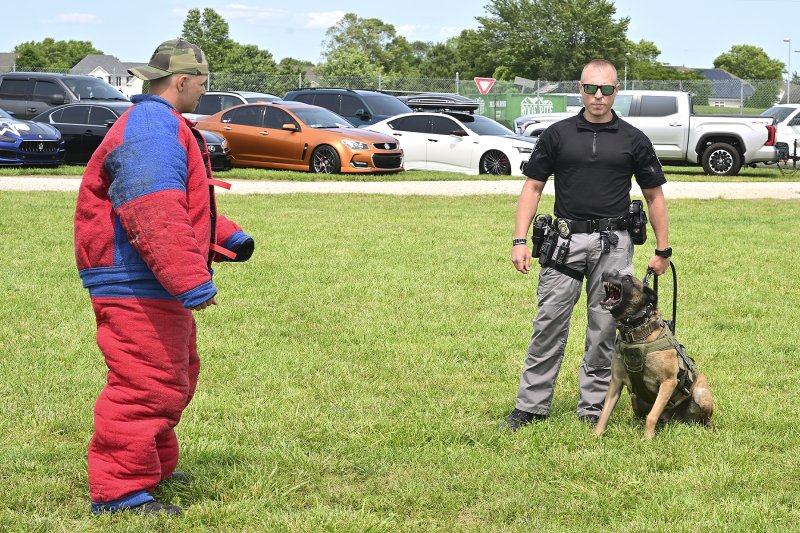 Cpl. Sean Jacobs of the Delaware State Police works with Miles Kosiorowski and his K9 Mason of the Milford Police Department.