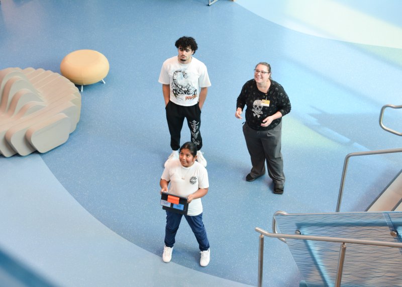 Observing the experiment are in back (l-r) Cape High student Ryder Bodis and physics teacher Priscilla Coolbaugh. In front, Lewes Elementary student Karla Ortiz Hernandez measures the amount of time it takes for a tennis ball to fall to the floor. SUBMITTED PHOTOS