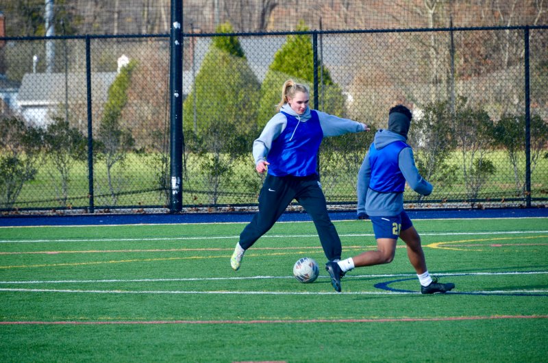 Class of 2024 graduate Carmen Merrick tries to get past 2025 graduate Andres Romero.