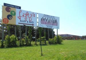 A sign on Route 1 with a large arrow pointing to the new building says to expect a fall 2016 opening. BY CHRIS FLOOD