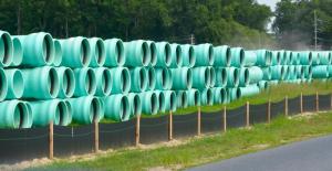 Large sewer pipes are piled and ready to be buried along a 10-mile stretch from the county’s Inland Bays treatment plant to a new state-of-the-art pump station on Route 1 near Lewes. RON MACARTHUR PHOTO