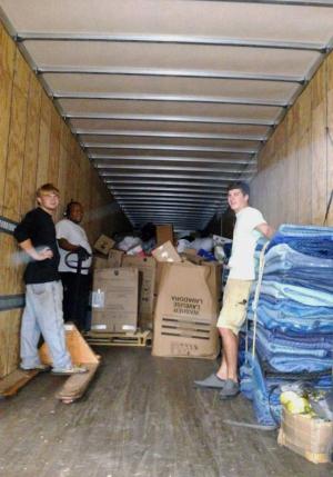 Filling up a tractor-trailer with donations for Louisiana flood victims are (l-r) Bruce Chorman, Teyon Harmon and Matt Tull. AMY KRATZ PHOTO
