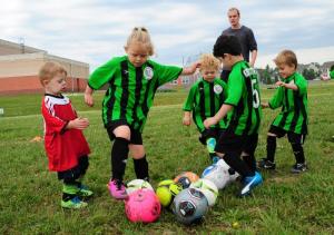 Coach Max Pereboom, back, referees as (l-r) Grady Dickerson mixes it up with Elise Russo-Kucek, Dane Irbin, Malec Ksebe and Luke Dickerson. DAN COOK PHOTO