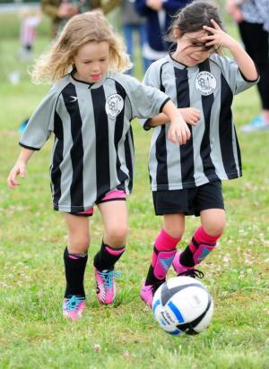 Stella Cats, 4, left, and Ashlyn Berlinger, 5, speed the ball upfield during a competitive 5- and 6-year-old game. DAN COOK PHOTO