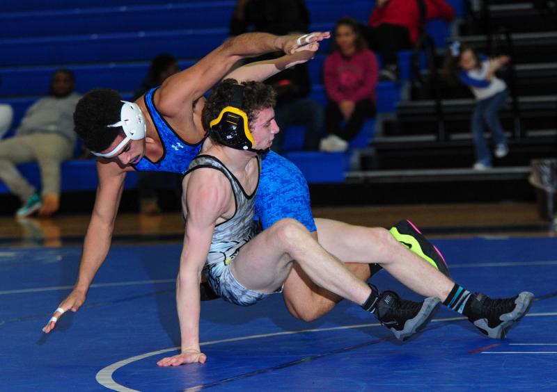 Cape’s Vinnie Diego goes to the mat with Dover’s Anthony Fisher and wins a 4-2 decision in the 138-pound class. DAN COOK PHOTO