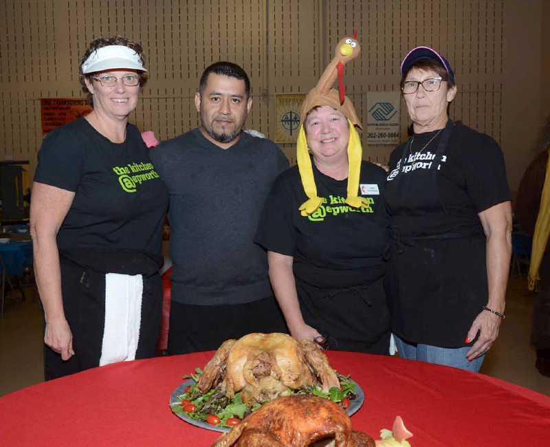 Epworth UMC Thanksgiving 2017 organizers gather by a couple of turkeys for a photo. Shown are (l-r) Cara Wilson, Chef Juan Escamilla, kitchen organizer Linda Kauffman and Penny MacLean. STEVEN BILLUPS PHOTO