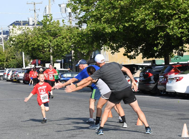 William Stauffer, 6, gets low fives from family members. DAVE FREDERICK PHOTOS