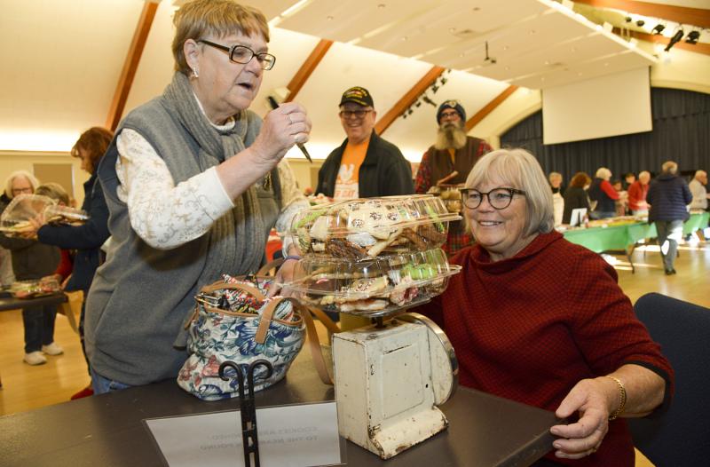 Pat Smidt from Catonsville UMC travels to Lewes for the Bethel Cookie Walk. Leslie Papp weighs her cookie picks. DENY HOWETH PHOTOS