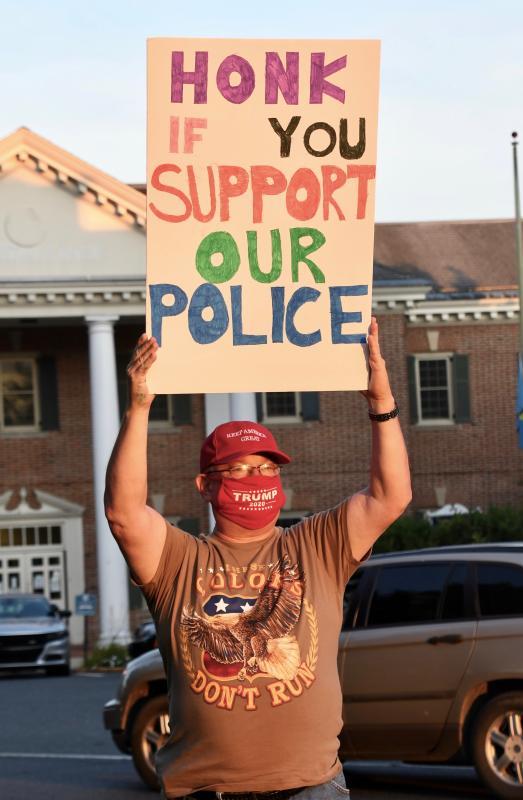Elmer Perry of Bridgeville asks people to honk their horns to support police.