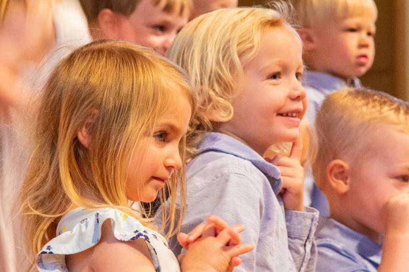 Hope Coulter, left, and Wesley Feindt wait with their Duckling Class to begin the next song.