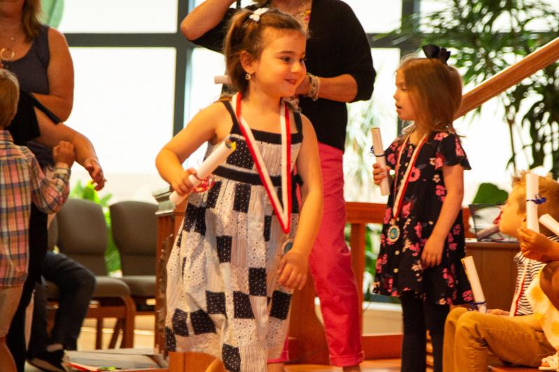 Penguin Class graduate Caroline Perniciaro proudly holds her diploma.