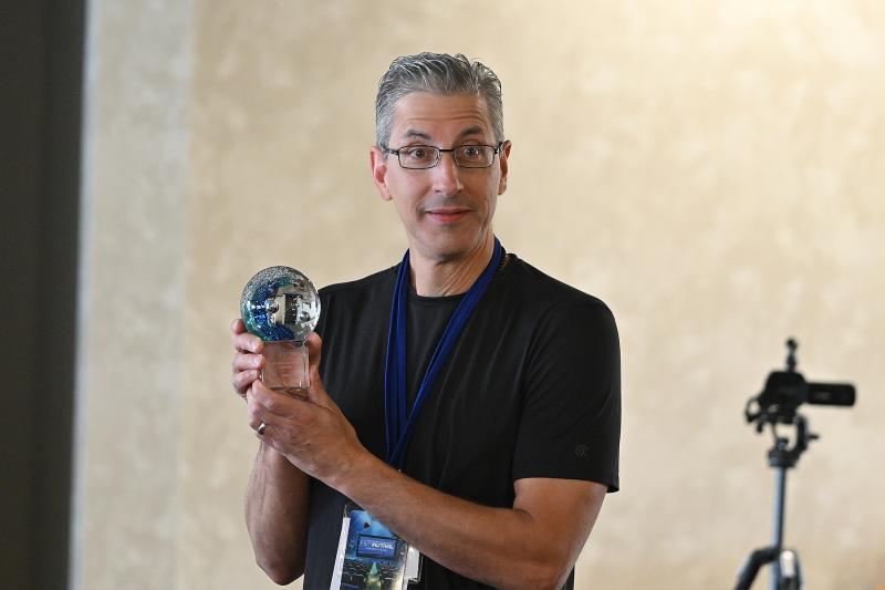 Gordon DelGiorno, festival director, accepts the award for Best Documentary Short on behalf of the winner who couldn’t be there.