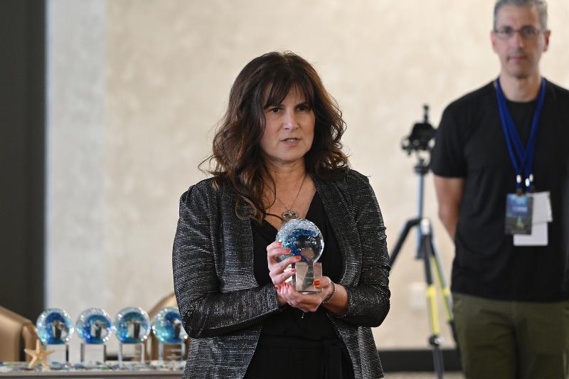 Toni Farina, producer of “Bau, Artist of War” accepts her award.