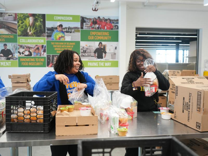 Mikaela Taylor, left, and Ruqayyah Barr, both students at Delaware State University and members of Sigma Gamma Rho, pack meal kits at the Food Bank of Delaware in Milford for the Martin Luther King Jr. Day of Service Jan. 20. ELLEN MCINTYRE PHOTOS
