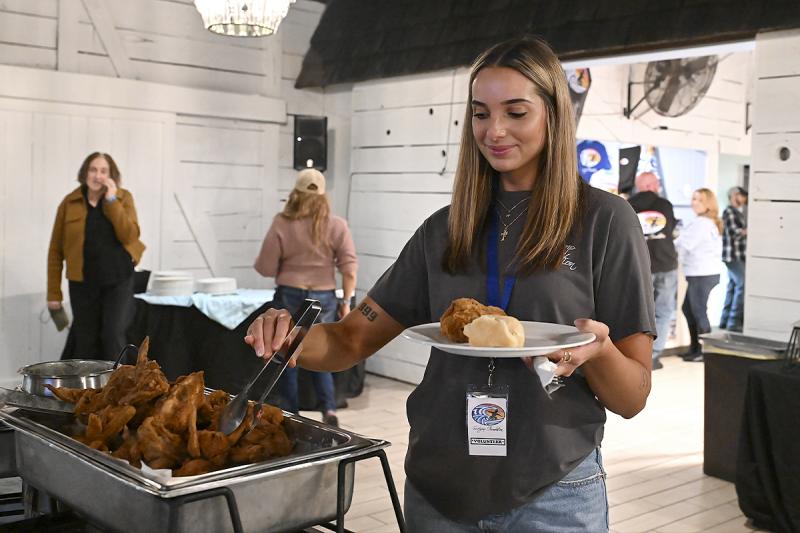 Katlyn Melendez, a volunteer for the Surfgimp Foundation, grabs a little dinner.