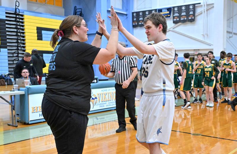 Cape head coach Katie Collick congratulates Danny Gartman on his game.