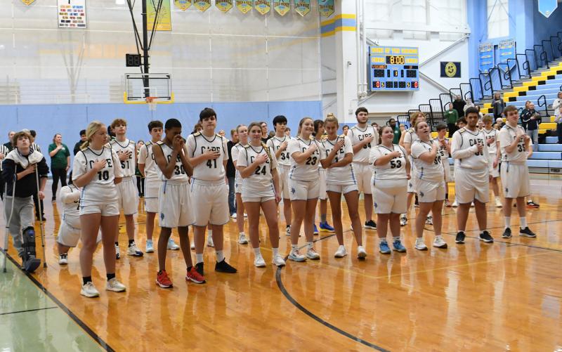 The unified team honors America during the national anthem.