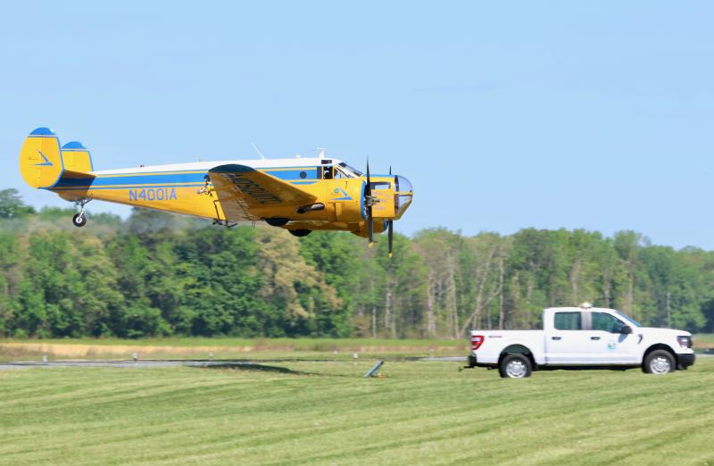 Mark Greenly flies one of Chorman Aerial Spraying’s two twin-engine Beechcraft mosquito sprayers over a piece of equipment called a spinner. DNREC set up the testing equipment at Chorman Airport near Greenwood for annual calibration of the planes’ nozzles. The planes spray the chemical on the spinner. DNREC scientists then analyze the size of the droplets under a microscope to make sure they meet specifications. BILL SHULL PHOTOS