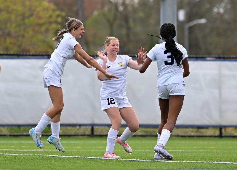 Zoey Neufeld, center, celebrates her winning JV goal with Alisa Tsirtsan, left, and Alexa Brown.