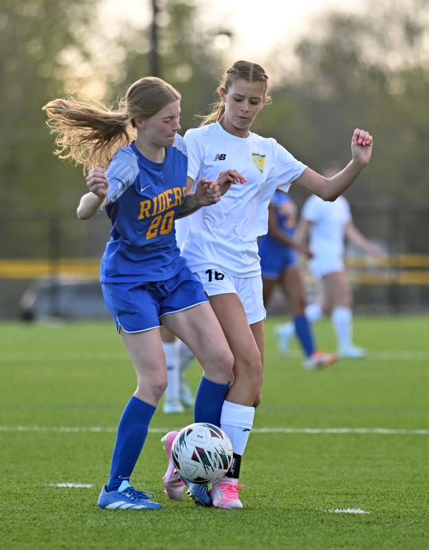 Cape freshman Lindsay Hassell, right, battles for control with Caesar Rodney’s Emma Oehmke.