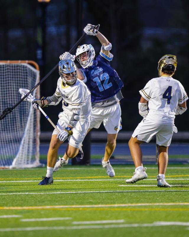 Cape defender Eric Uffelman checks the stick of a Sallies attacker.