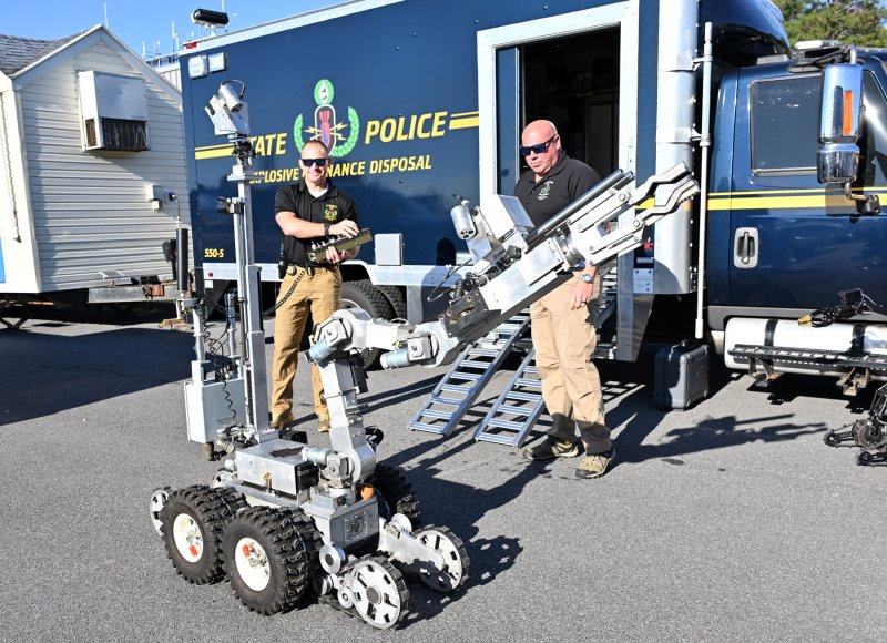 The Delaware State Police Bomb Squad prepares a robot for 911 Awareness Day. Operating the robot are Lt. Brett Cordrey, left, and Sgt. Frank Fuscellaro.