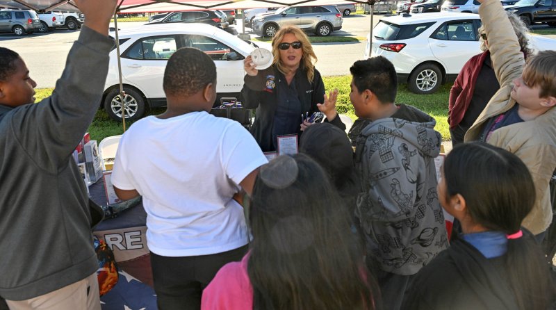 Rebekah Legar of the Delaware State Fire Marshal’s office reviews the use of a smoke detector.