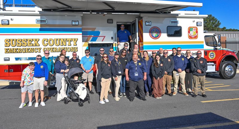 Sussex County Emergency Operations staff pose next to their mobile command center.