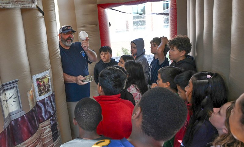 Jim Harrison explains the use of a smoke detector.