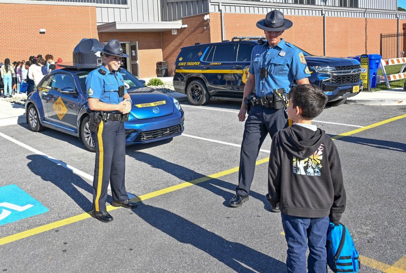 Fourth-grader Jayden Lynch, right, speaks with Cpl. Christine Bowie and field training officer Patrick Jackson.